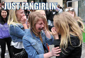 Two girls crying while consoling each other, with the meme caption: “Just fangirlin'”