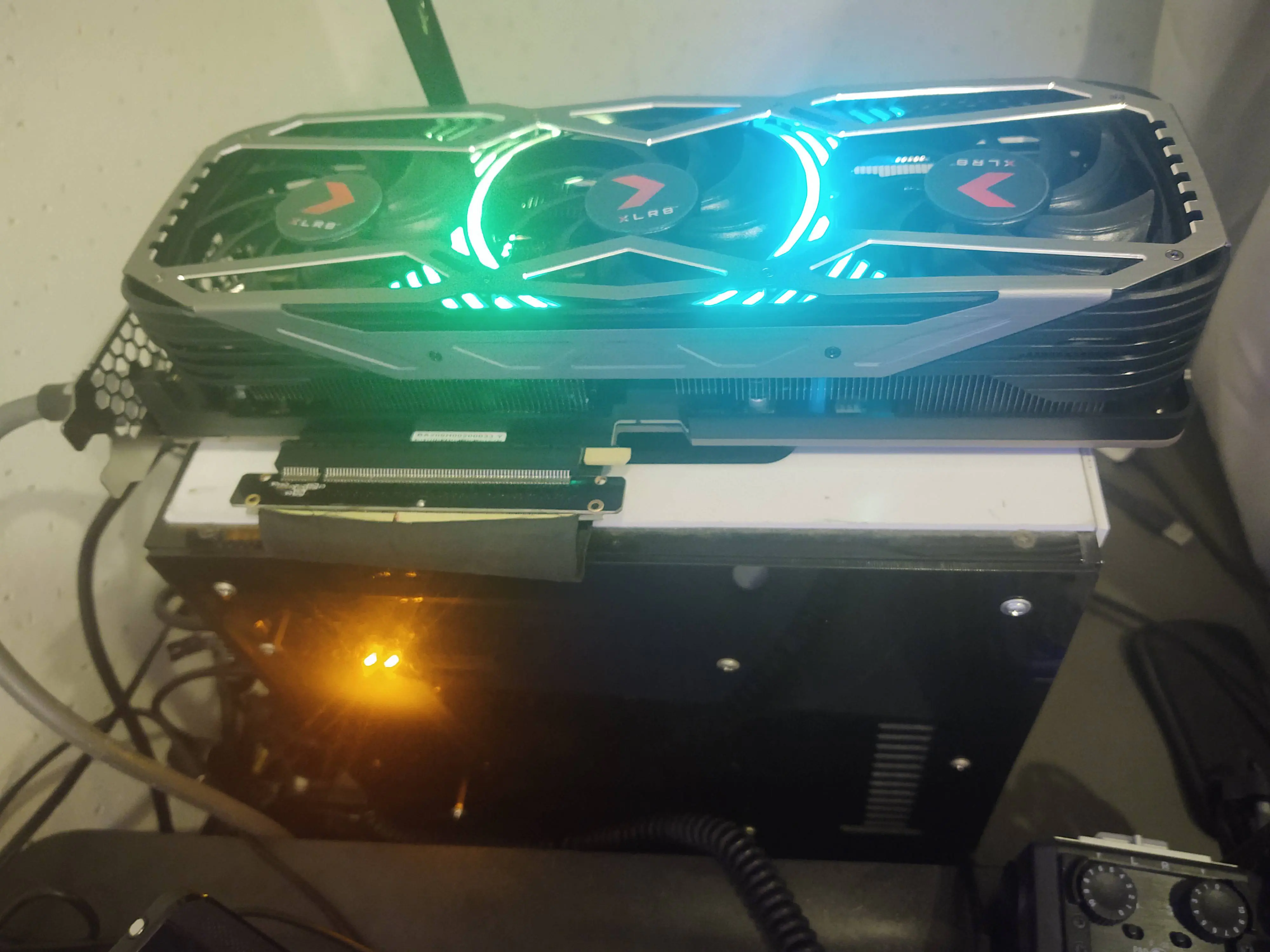 A personal computer with graphics card sitting outside of its case.