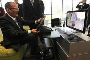 President Benigno Aquino, Jr. enjoying a racing game.