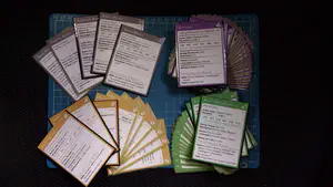 Four stacks/spreads of home-made Dungeons & Dragons cards, featuring the characters from the Dicecast campaign.