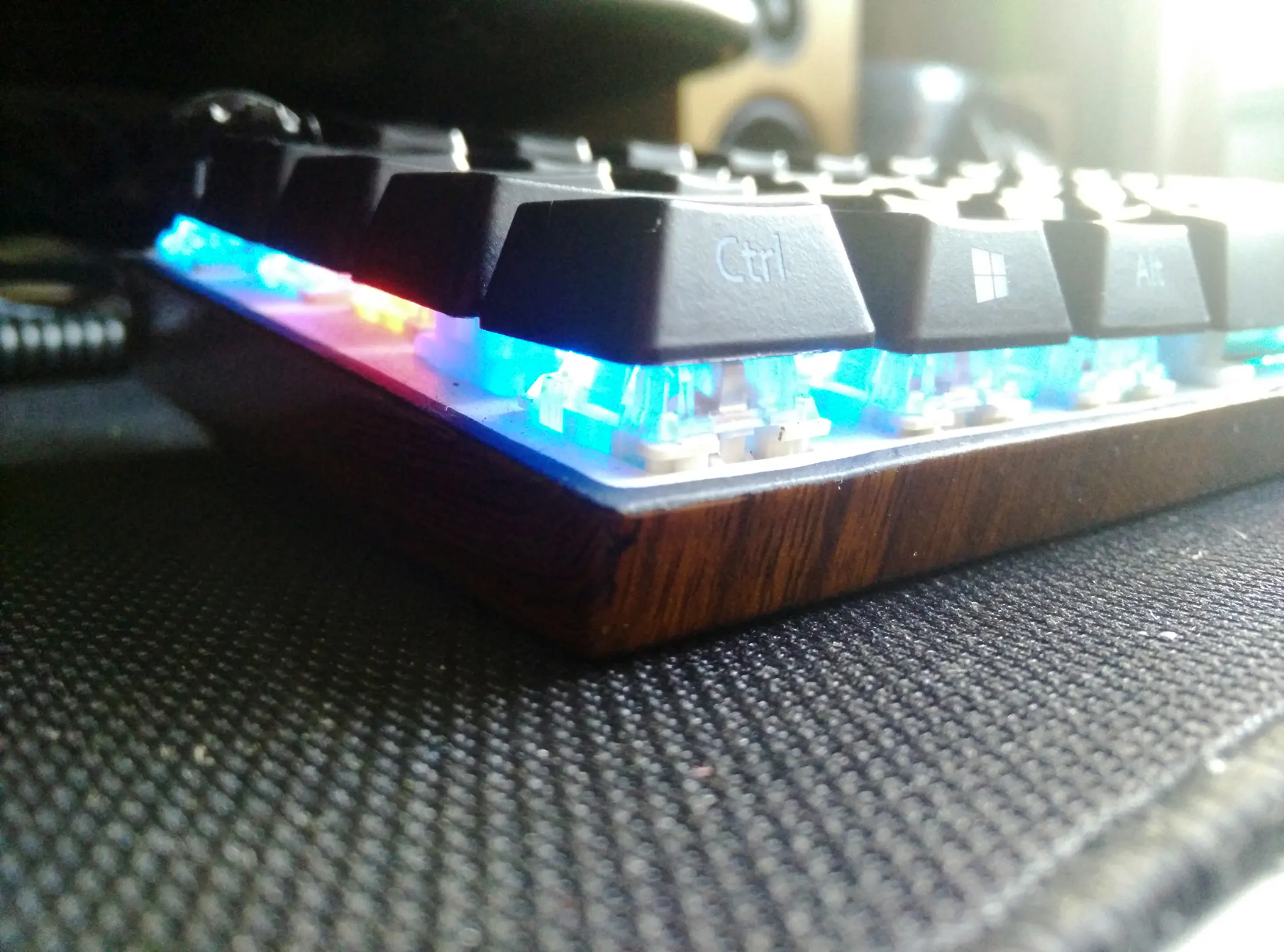 Photo of a custom hydrodipped keyboard case in wood grain paint.