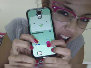 Megan Young posing with a Beemo-themed phone case.