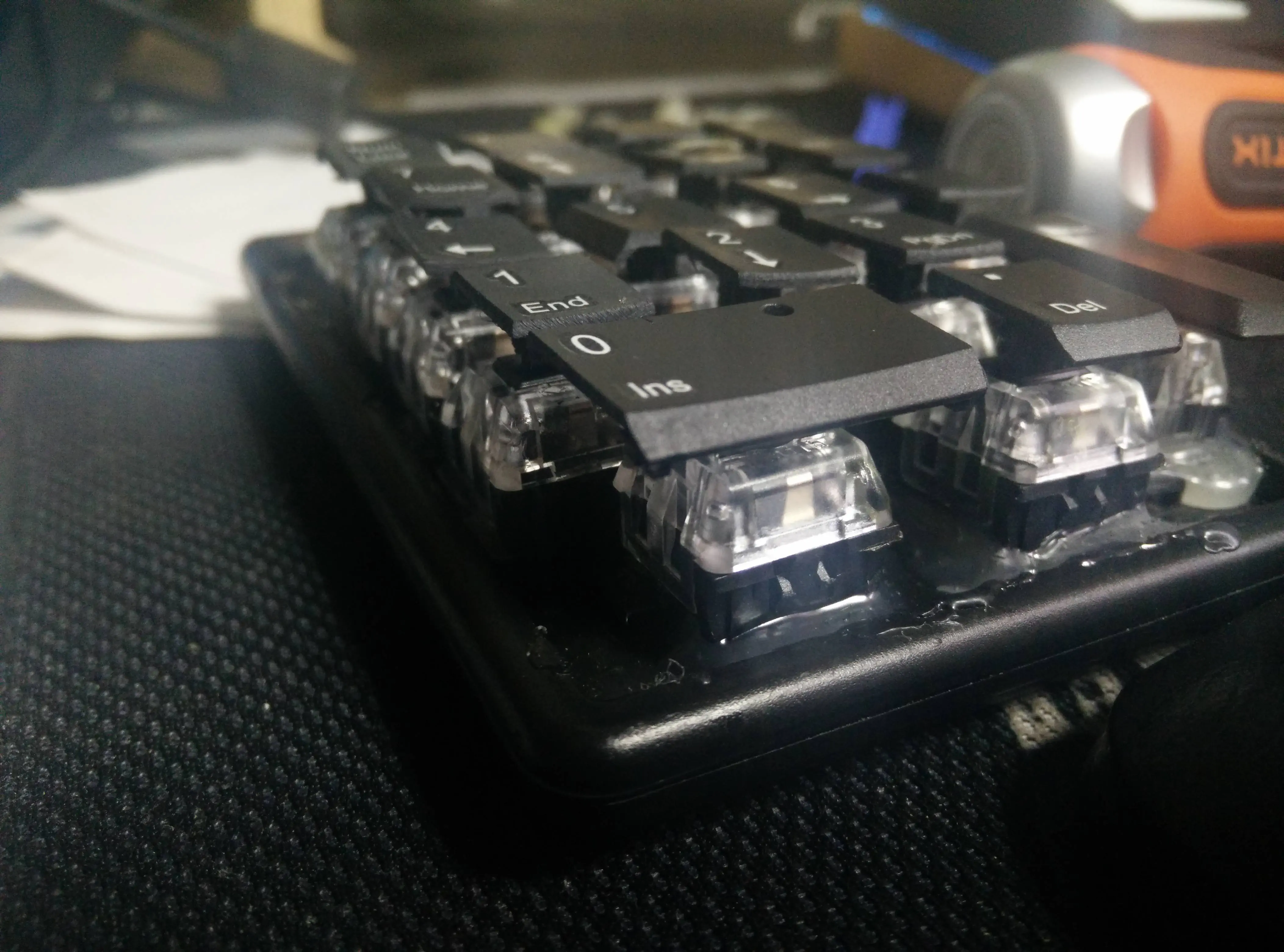 Photo of a badly-modified number pad keyboard, whose rubber membrane domes were swapped out for mechanical switches.