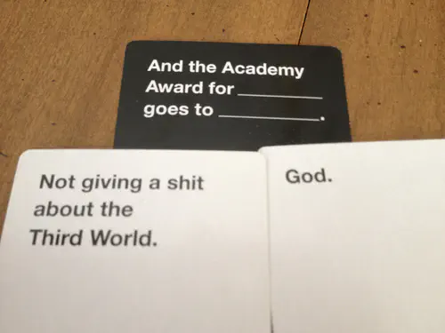 Cards Against Humanity combo. Black card: “And the Academy Award for (blank) goes to (blank).” White card 1: “Not giving a shit about the Third World.” White card 2: “God.”