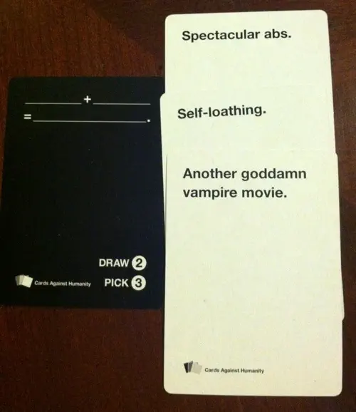 Cards Against Humanity combo. Black card: “(blank) + (blank) = (blank)” White card 1: “Spectacular abs.” White card 2: “Self-loathing.” White card 3: “Another goddamn vampire movie.”